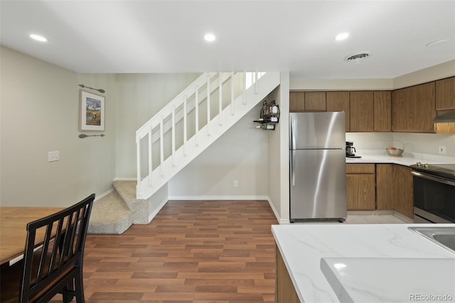 kitchen with appliances with stainless steel finishes and dark wood-type flooring