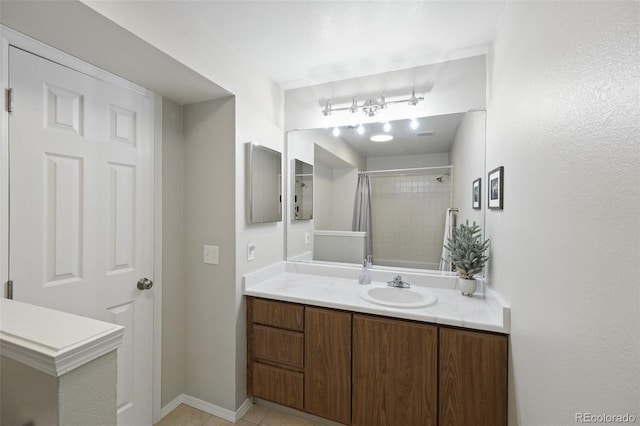 bathroom featuring walk in shower, tile patterned floors, and vanity