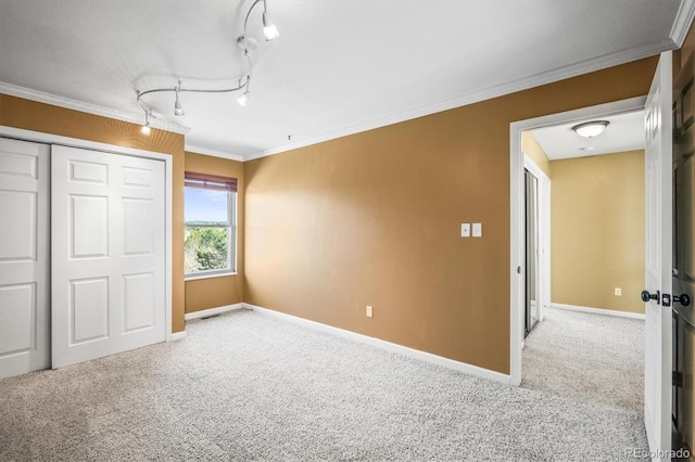 unfurnished bedroom with baseboards, ornamental molding, and light colored carpet