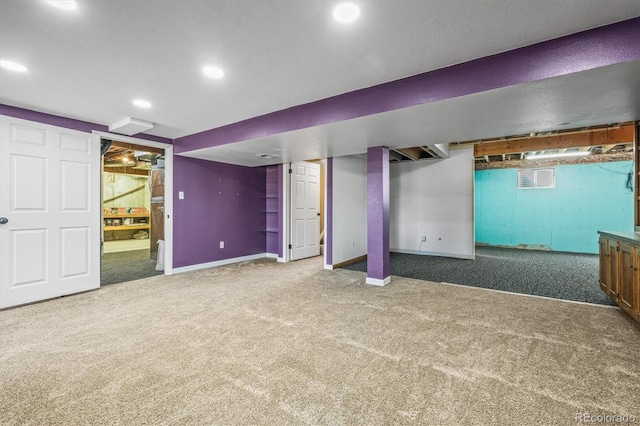 basement featuring carpet, baseboards, and recessed lighting