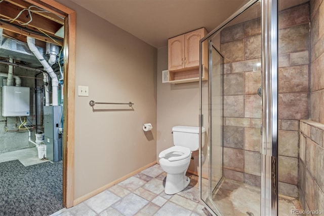 bathroom with water heater, toilet, stone finish floor, a shower stall, and baseboards