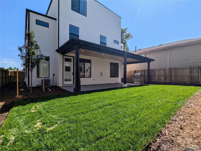 back of property featuring a yard, a patio area, and central air condition unit