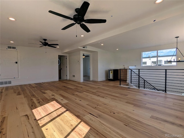 unfurnished living room featuring sink and light wood-type flooring