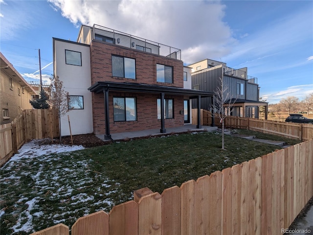 view of front of property with a patio area and a front lawn