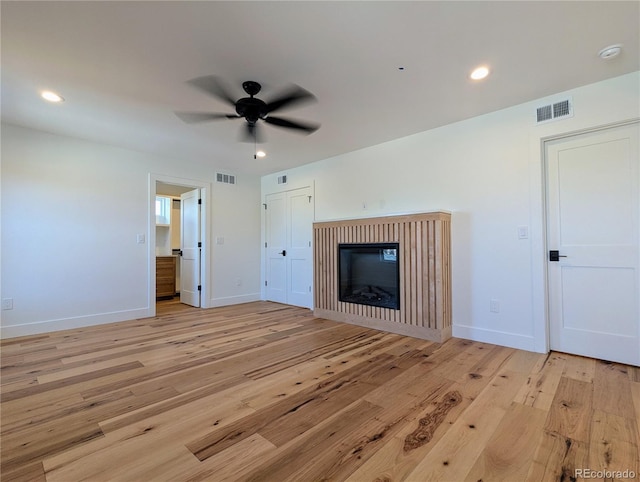 unfurnished living room featuring ceiling fan and light hardwood / wood-style floors