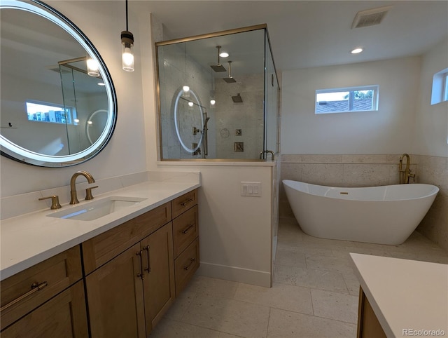 bathroom featuring vanity and separate shower and tub