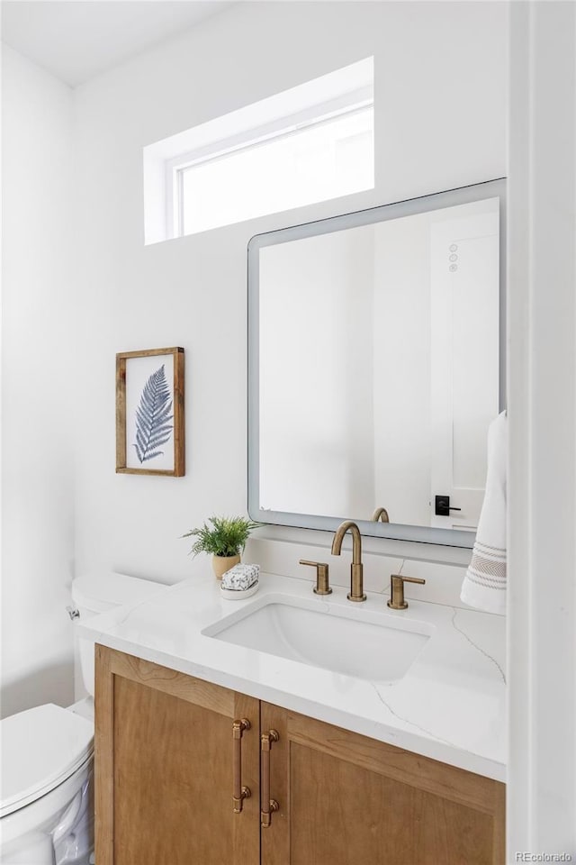 half bath with vanity and toilet