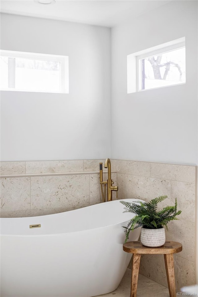 full bath featuring a soaking tub