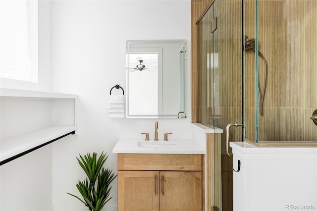 full bath with ceiling fan, an enclosed shower, and vanity