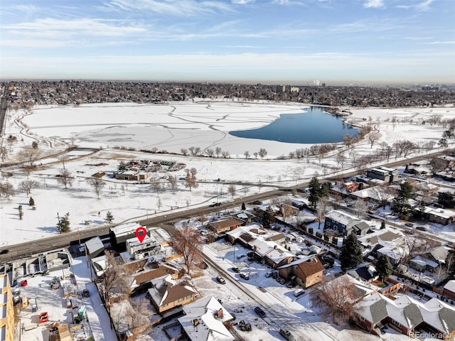 snowy aerial view featuring a water view