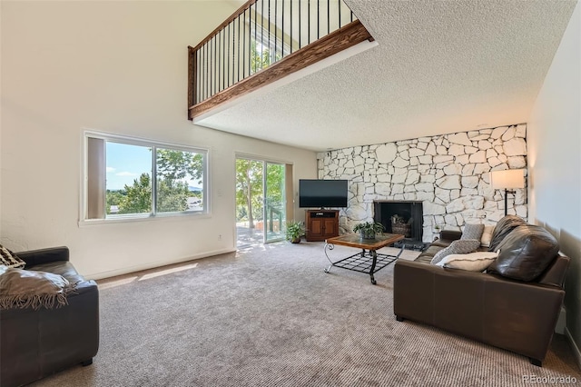 11410 W 72nd Pl, Arvada, CO 80005 - living room featuring carpet, a textured ceiling, and a stone fireplace