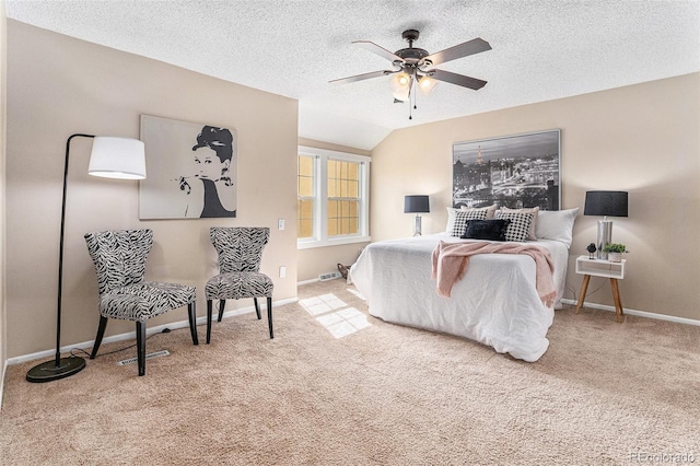 carpeted bedroom with a ceiling fan, vaulted ceiling, a textured ceiling, and baseboards