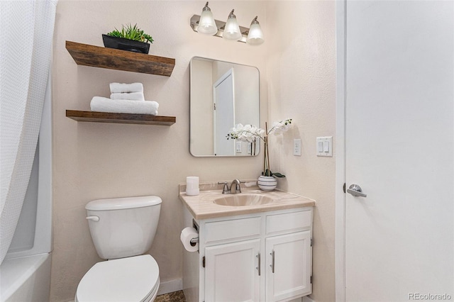 bathroom featuring toilet and vanity