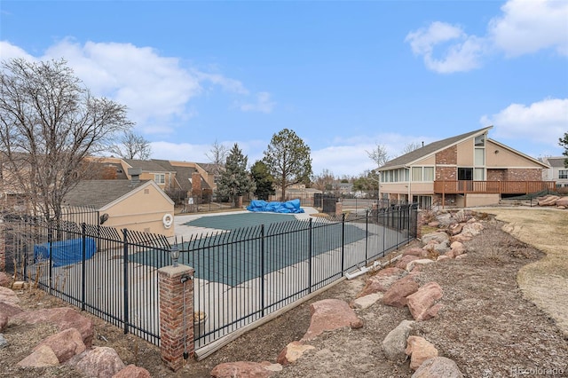 view of pool with a residential view and fence