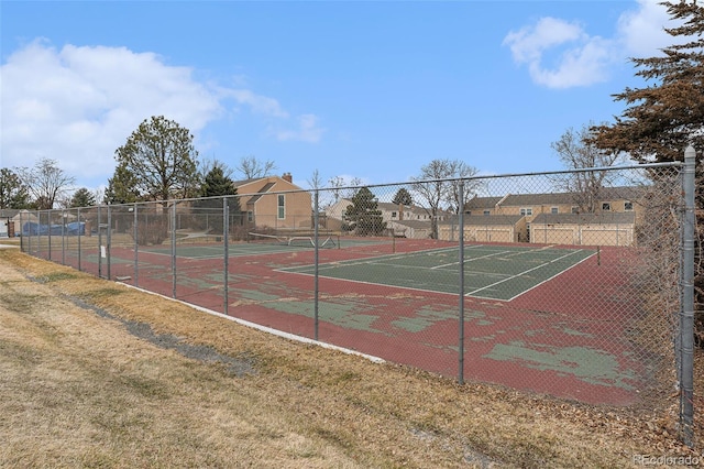 view of tennis court featuring fence