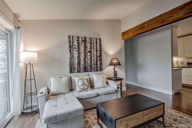 living area featuring light wood-style flooring and baseboards