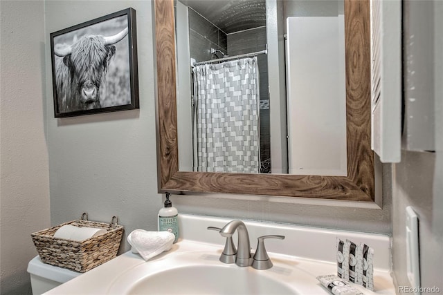 bathroom with toilet, vanity, and curtained shower