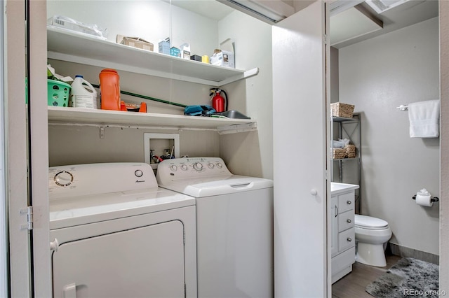 laundry room with washer and dryer, laundry area, and light wood finished floors
