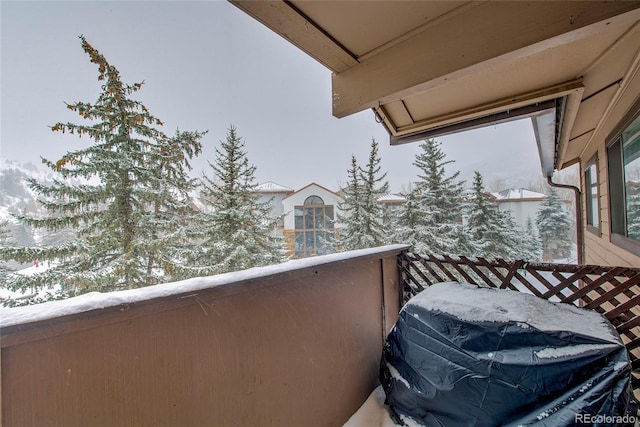 view of snow covered back of property