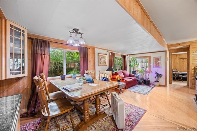 9129 Rampart St, Denver, CO 80260 - dining room with wood walls, light wood-style flooring, and a chandelier