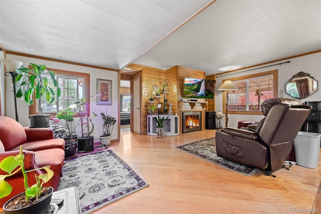 9129 Rampart St, Denver, CO 80260 - living area featuring wood walls, wood finished floors, crown molding, and a glass covered fireplace