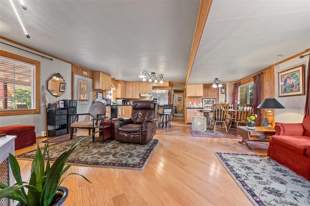 9129 Rampart St, Denver, CO 80260 - living area featuring light wood finished floors, wood walls, and beamed ceiling