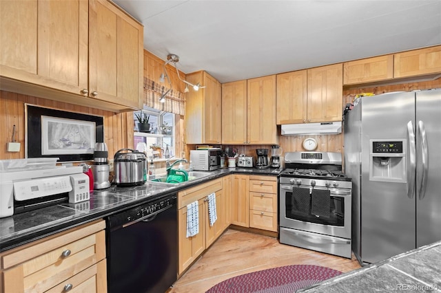 9129 Rampart St, Denver, CO 80260 - kitchen featuring appliances with stainless steel finishes, under cabinet range hood, light brown cabinetry, dark countertops, and light wood-style flooring