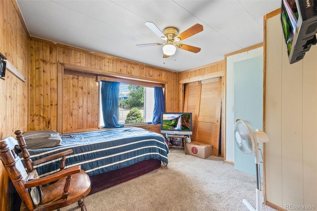 9129 Rampart St, Denver, CO 80260 - carpeted bedroom with wood walls, a closet, and a ceiling fan