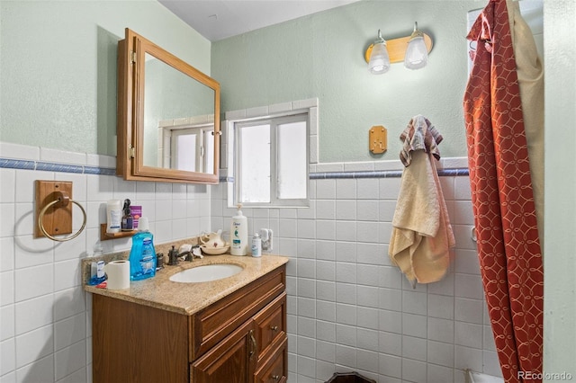 9129 Rampart St, Denver, CO 80260 - bathroom featuring tile walls, vanity, and wainscoting