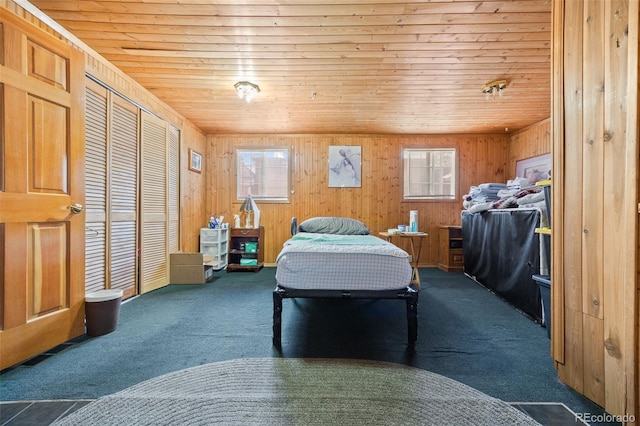 9129 Rampart St, Denver, CO 80260 - bedroom featuring wooden ceiling, multiple windows, carpet, wood walls, and a closet