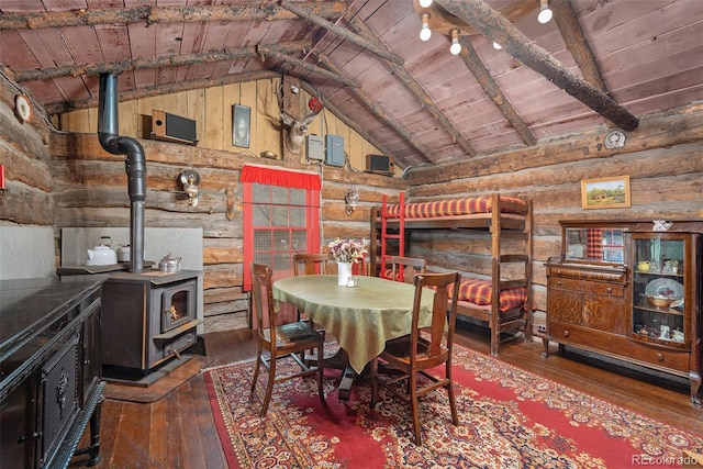 dining space with wood ceiling, dark wood-type flooring, log walls, beamed ceiling, and a wood stove