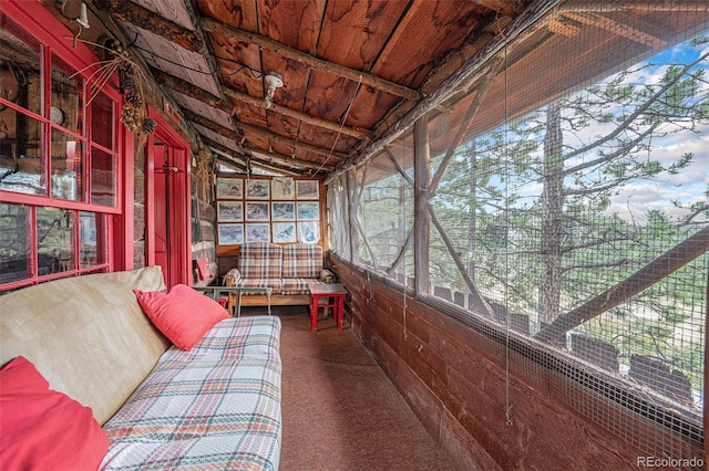 unfurnished sunroom with vaulted ceiling and wooden ceiling