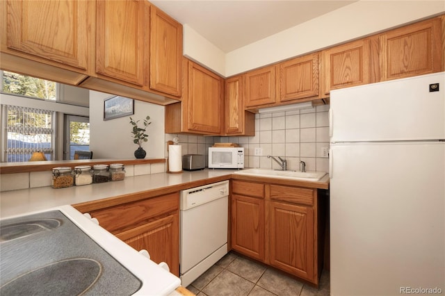 217 Van Anderson Dr Unit 6, Winter Park, CO 80482 - kitchen featuring light tile patterned floors, light countertops, decorative backsplash, a sink, and white appliances