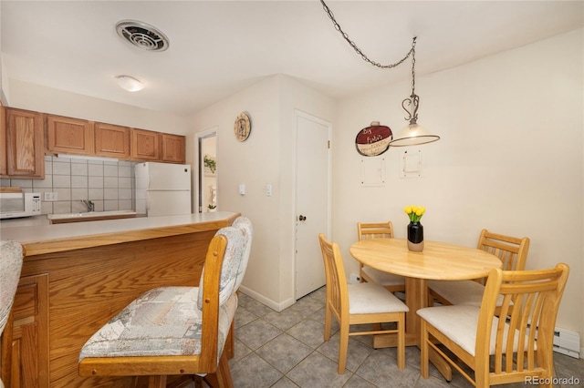 217 Van Anderson Dr Unit 6, Winter Park, CO 80482 - dining space featuring light tile patterned floors, baseboards, and visible vents