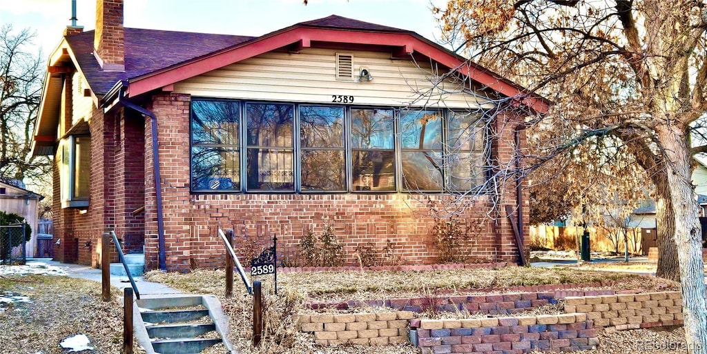 view of front facade with a sunroom