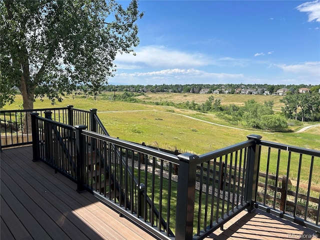 1495 Goldsmith Dr, Highlands Ranch, CO 80126 - wooden deck featuring a view of rural / pastoral area, stairway, and a yard