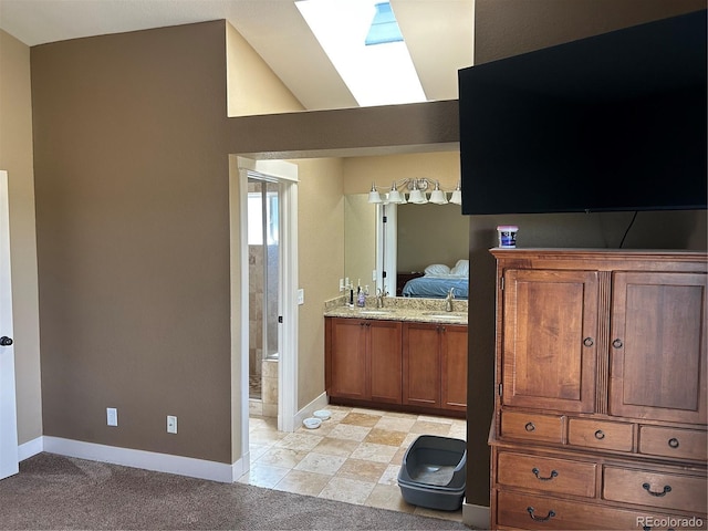 1495 Goldsmith Dr, Highlands Ranch, CO 80126 - bathroom with a skylight, ensuite bath, vanity, and vaulted ceiling