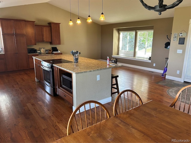 1495 Goldsmith Dr, Highlands Ranch, CO 80126 - kitchen with stainless steel appliances, dark wood-style flooring, a kitchen island, vaulted ceiling, and pendant lighting