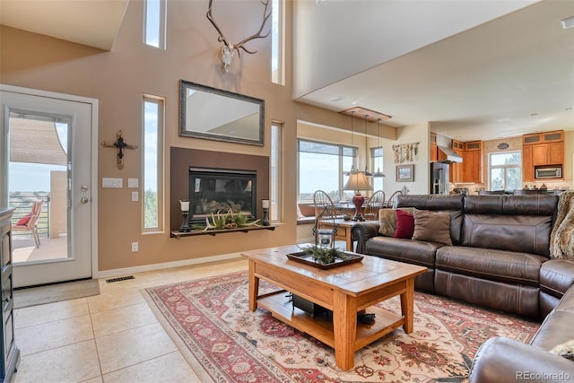 tiled living room with a towering ceiling