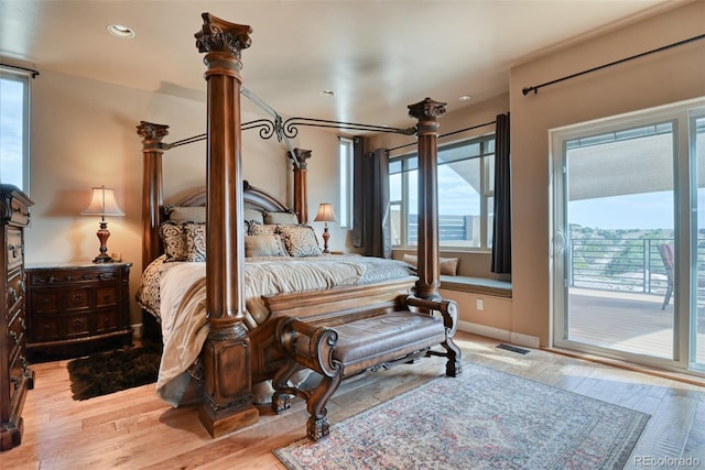 bedroom with light wood-type flooring and access to outside