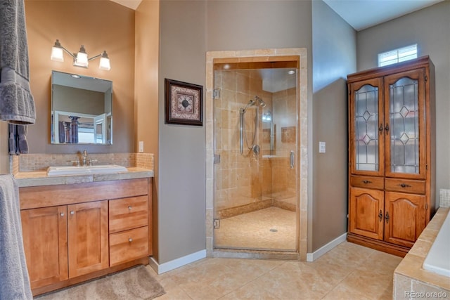 bathroom featuring tile patterned floors, vanity, and a shower with door