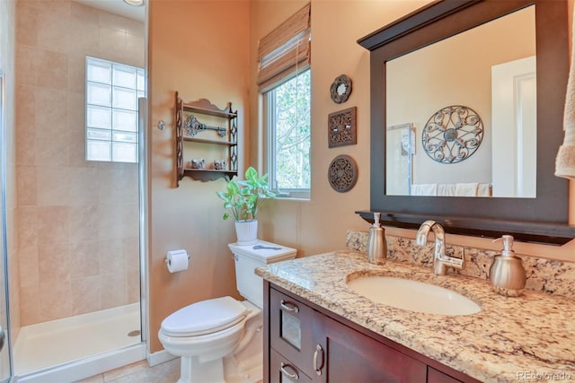 bathroom featuring toilet, an enclosed shower, vanity, and tile patterned floors