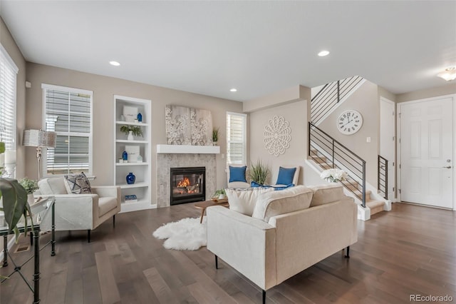 540 E Fremont Pl, Centennial, CO 80122 - living area with wood finished floors, stairway, a glass covered fireplace, built in shelves, and recessed lighting
