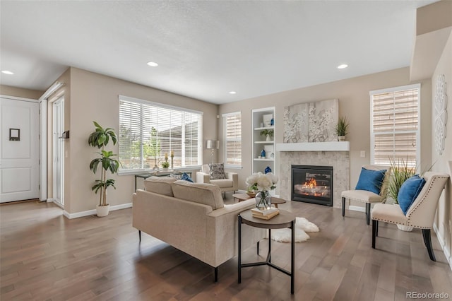 540 E Fremont Pl, Centennial, CO 80122 - living area with wood finished floors, a fireplace, baseboards, built in features, and recessed lighting