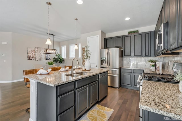 540 E Fremont Pl, Centennial, CO 80122 - kitchen with appliances with stainless steel finishes, a sink, dark wood finished floors, backsplash, and recessed lighting