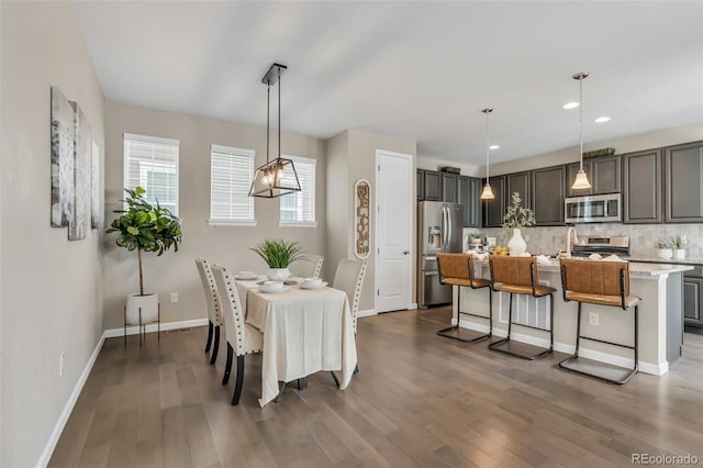 540 E Fremont Pl, Centennial, CO 80122 - dining space with wood finished floors, baseboards, recessed lighting, and a chandelier