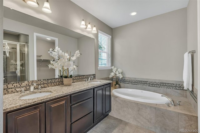 540 E Fremont Pl, Centennial, CO 80122 - full bathroom featuring a garden tub, tile patterned floors, a shower stall, and double vanity