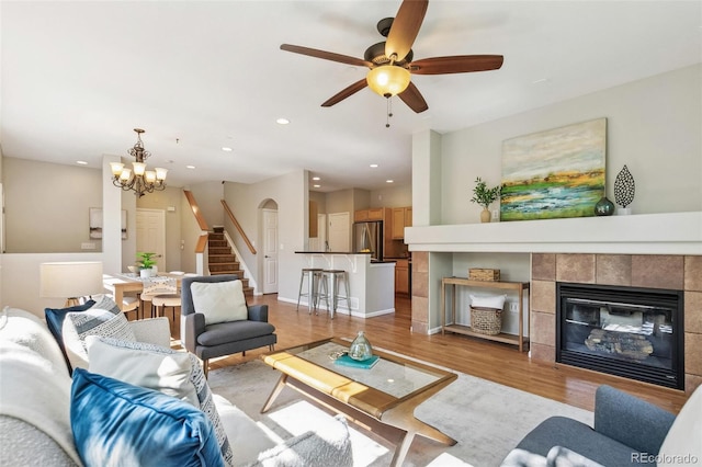 14247 W 84th Cir Unit A, Arvada, CO 80005 - living room with stairway, light wood-style flooring, recessed lighting, a chandelier, and ceiling fan