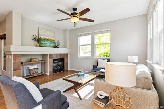14247 W 84th Cir Unit A, Arvada, CO 80005 - living area featuring wood finished floors, a tile fireplace, and ceiling fan