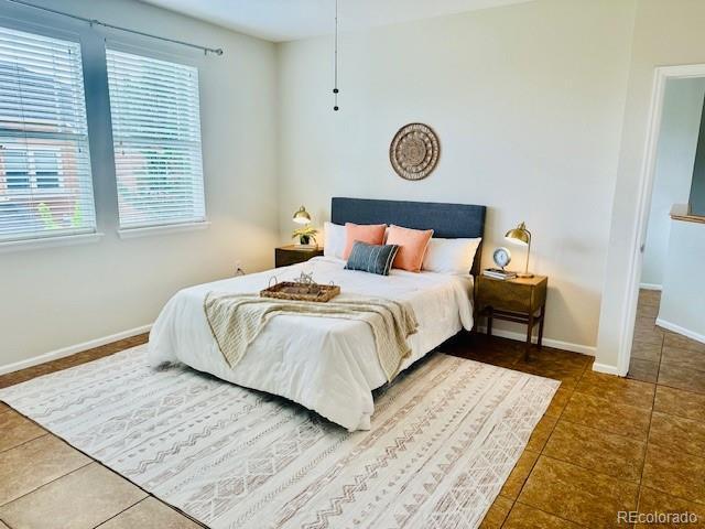 14247 W 84th Cir Unit A, Arvada, CO 80005 - tiled bedroom with baseboards